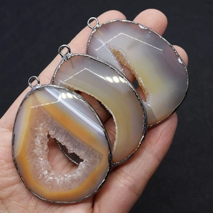 Natural agate druzy pendant with irregular teardrop shape and silver metallic edging
