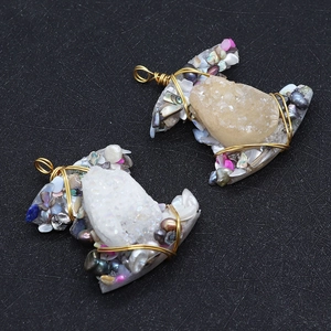 Macro shot of handmade wire-wrapped crystal cluster and baroque pearl pendant details