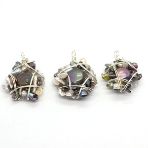 Baroque irregular pearl pendants with silver wire wrap craftsmanship on white background