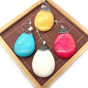 Natural teardrop stone pendants set in blue, white, pink, and yellow with crystal-paved bails