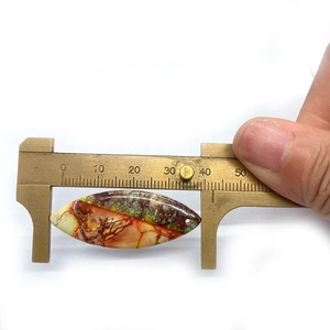 Detailed measurement of rice-shaped natural turquoise stone pendant showing dimensions