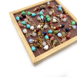 Mix of teardrop-shaped natural stone pendants with gold caps for DIY jewelry making