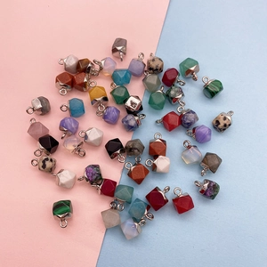 Macro view of multifaceted natural stone pendants with silver caps for DIY jewelry