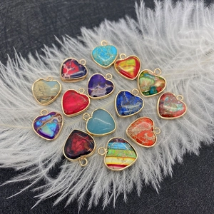 Set de colgantes de piedra imperial en forma de corazón con bordes dorados y plumas