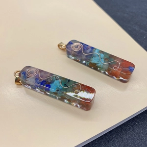 Close-up detail of rectangular resin pendants filled with colorful natural stone chips