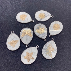 Detailed collection of teardrop stone pendants featuring gold butterfly and star patterns