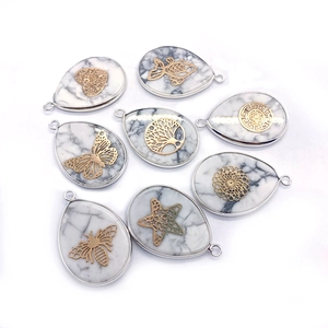 Set of 8 teardrop white turquoise pendants with various golden metal pattern overlays