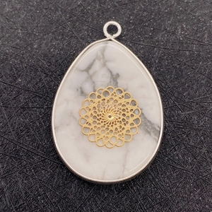 Teardrop white turquoise pendant with golden mandala overlay and silver metal edging