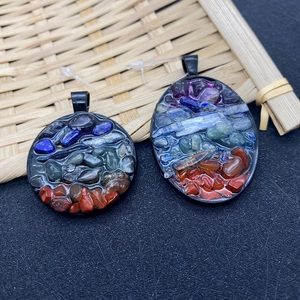 Detailed macro view of oval and round pendants with colorful natural chakra stones