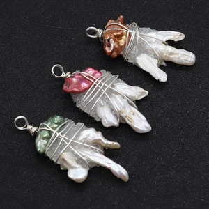 Detailed macro of handmade baroque pearl pendants with wrapped silver wire and crystal clusters