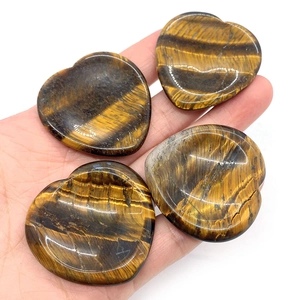 Four natural tiger eye stones in heart shape with polished golden brown textures