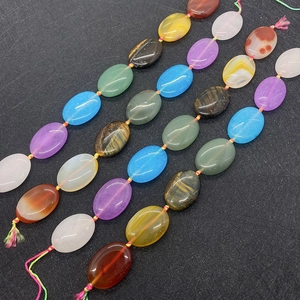Detailed view of 18x25mm oval natural stone beads with smooth finish for DIY jewelry