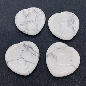 Set of four heart-shaped white howlite thumb stones with natural grey marble textures