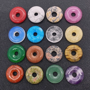Collection of 16 natural stone donut pendants in various colors and textures for DIY