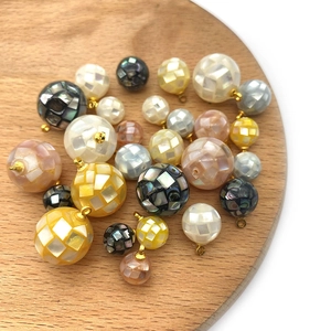 Natural round mosaic shell pendants with gold connectors in white, yellow and black tones