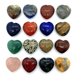 Macro view of 16 assorted heart-shaped natural gemstones with smooth polished finish