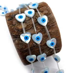 Natural heart-shaped shell evil eye beads for DIY jewelry making on wooden prop