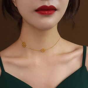 Elegant gold choker necklace featuring dual hollow rose pendants on a delicate link chain