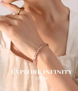 Detail of pink zircon tennis bracelet with 18K gold-plated setting on model's wrist