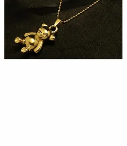 Macro shot of detailed 18K gold plated teddy bear pendant with a classic ball chain necklace