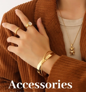 Detailed close-up of 18K gold plated jewelry set featuring bear pendant and rings