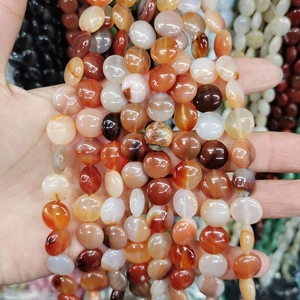 Detailed close-up of natural grey agate and white turquoise loose beads for DIY jewelry making