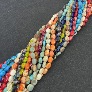 Macro shot of colorful oval emperor stone beads with natural texture for DIY jewelry making