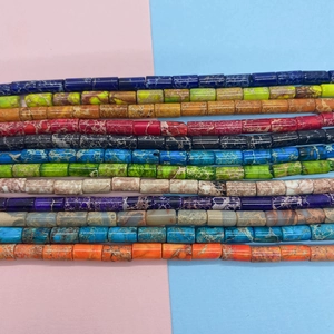 Macro shot of 4x8mm colorful cylindrical natural stone beads with unique marble textures