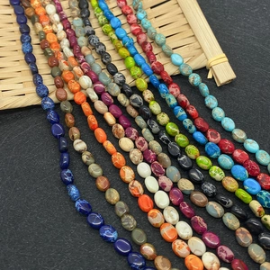 Colorful 6x8mm oval natural stone beads for DIY jewelry making displayed on a bamboo tray