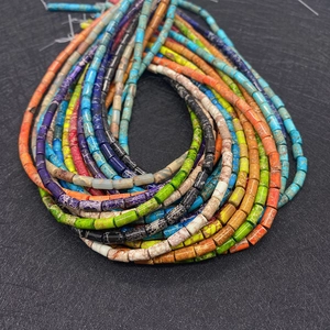 Macro shot of colorful cylindrical imperial stone beads with natural mineral textures