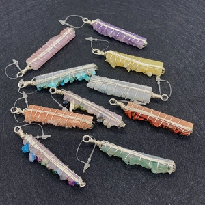 Macro view of assorted wire-wrapped natural crystal pendants in various gemstones