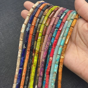 Handheld view of multi-colored 5x13mm cylindrical imperial stone beads for DIY jewelry