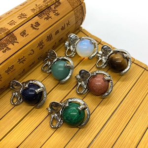Detail of elephant gemstone pendants in various natural stones on a bamboo mat
