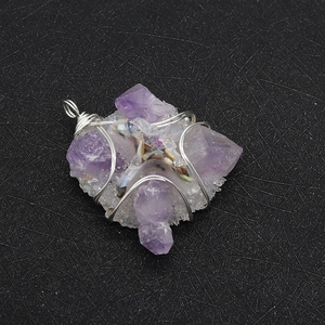 Detailed view of handmade silver wire wrapped natural amethyst crystal cross pendant