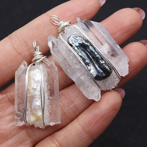 Detail of handmade crystal pendant with baroque pearl and intricate wire wrapping