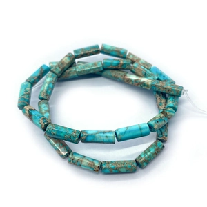 Macro shot of cylindrical blue imperial stone beads with natural brown mineral texture