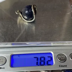 Blue goldstone pendant on digital scale showing 7.82 grams weight detail view