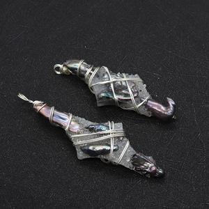 Detailed view of handmade baroque pearl and crystal wire-wrapped pendant