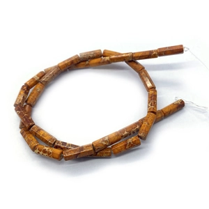 Close-up of cylindrical picture jasper stone beads with natural brown mesh patterns