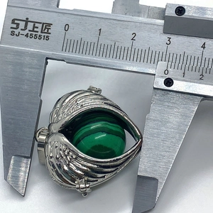 Measurement of a silver wing-shaped pendant featuring a green malachite stone ball