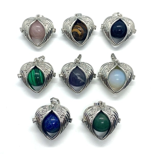 Lapis Lazuli and Opal heart wing pendants in silver metal frames on white background