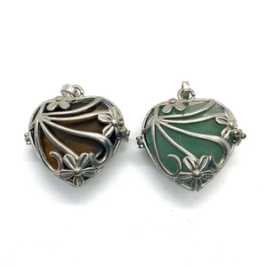 Hollow heart locket detail featuring tiger eye and green aventurine stones in silver frame