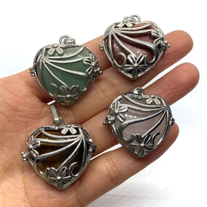 Set of four hollow heart-shaped gemstone pendants with intricate silver floral metal patterns