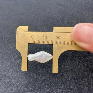 Macro shot of a fish-shaped baroque pearl measured at 16mm with a digital caliper