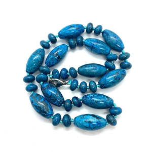 Detail of blue marbled stone cylinder beads and round spacer beads on a necklace