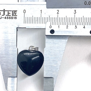 Detailed dimension measurement of the heart-shaped black onyx stone pendant with digital caliper