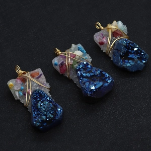 Macro detail of wire-wrapped natural blue crystal pendants with gold metal craftsmanship