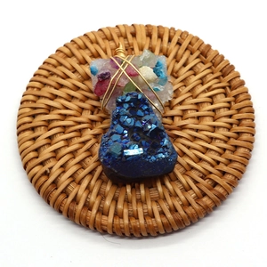 Natural blue crystal cluster wire wrapped pendant with multicolor stones on rattan mat