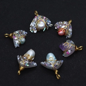 Macro view of six handmade wire wrapped natural pearl and resin stone pendants