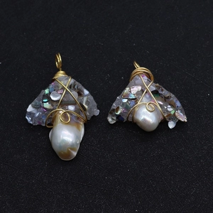 Detail of handmade gold wire wrapped baroque pearl pendant with colorful shell chips